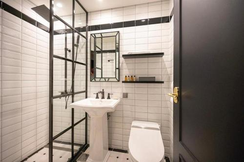 a white bathroom with a sink and a toilet at HOTEL D EDITION in Daejeon