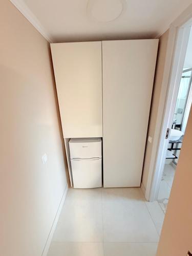 a closet in a room with a refrigerator at Arena 7-17 Central Suites in Cluj-Napoca