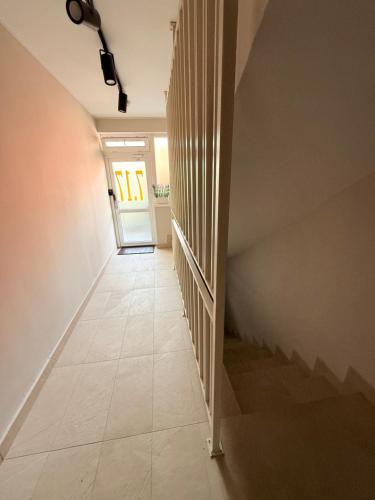 a hallway with a stairway with a door and a stair at Arena 7-17 Central Suites in Cluj-Napoca