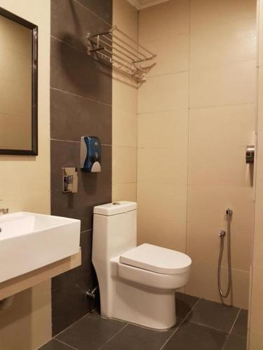 a bathroom with a white toilet and a sink at City View Hotel At KLIA & KLIA2 in Kuala Lumpur