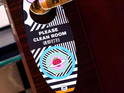 a sign for a clean room with a strawberry on it at Radegast Hotel CBD in Beijing
