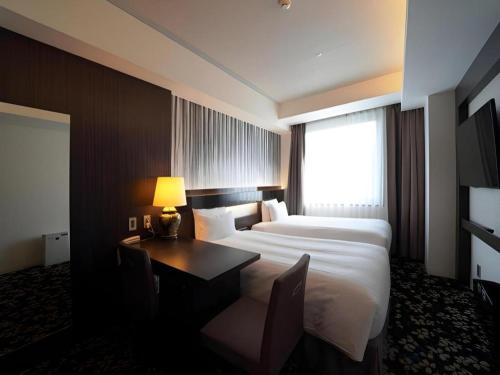 Hotel Riverge Akebonoにあるベッド