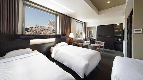Hotel Riverge Akebonoにあるベッド
