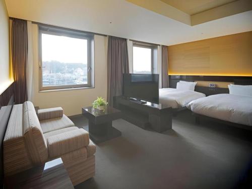 Hotel Riverge Akebonoにあるベッド