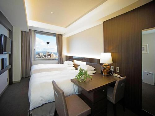 Hotel Riverge Akebonoにあるベッド