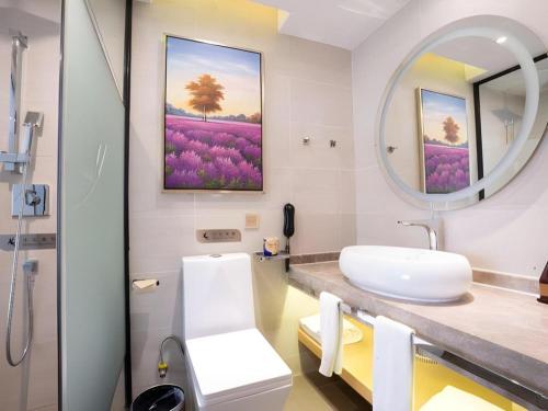 ein Badezimmer mit Waschbecken und Spiegel in der Unterkunft Lavande Hotel Foshan Shunde Shunlian Plaza Jinlong Metro Station in Shunde
