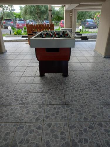 a pool table on a tile floor in a building at olivensun apartment 6 in Gythio