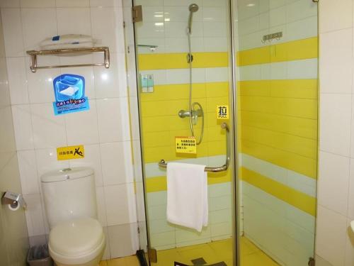 a bathroom with a toilet and a glass shower at 7 Days Inn Wuhan Hanyang Wanda Plaza in Wuhan