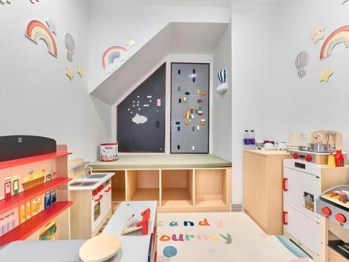 a childs play room with a window with rainbow decals at Huafa Executive Apartment Hotel Zhuhai in Zhuhai