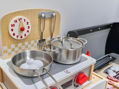 a kitchen with two pots and pans on a stove at Huafa Executive Apartment Hotel Zhuhai in Zhuhai