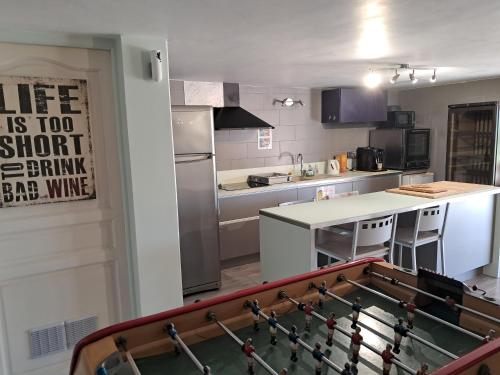 a kitchen with a ping pong table in the middle at La Bastide Des Selves in Draguignan