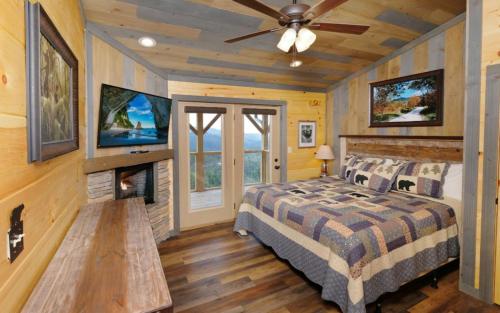 a bedroom with a bed and a fireplace at Bigger Bear Views Lodge in Gatlinburg