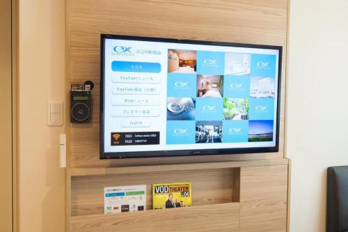 a flat screen tv sitting on top of a shelf at KEIKYU EX INN Keikyu Kawasaki-Station in Kawasaki