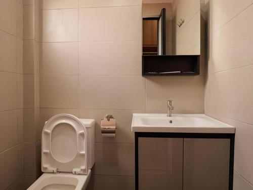 a bathroom with a toilet and a sink at Weiss Hotels Kepong Baru in Kuala Lumpur