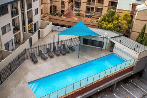 an overhead view of a swimming pool on a building at Spacious Apartment in East Perth - Close to OPTUS Stadium, CBD, WACA in Perth