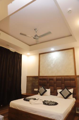 a hotel room with a bed with a ceiling at The Blessing Palace in Muzaffarpur