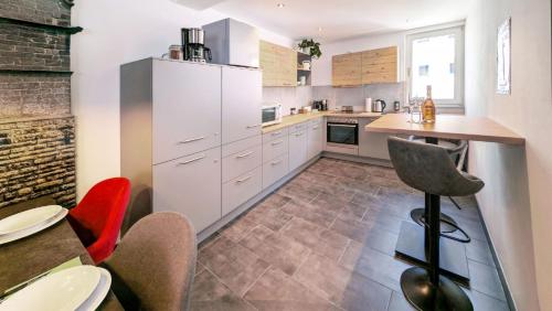 a kitchen with white cabinets and a table and chairs at Ferienwohnung Rottweil Zentrum - Parkplatz kostenlos in Rottweil