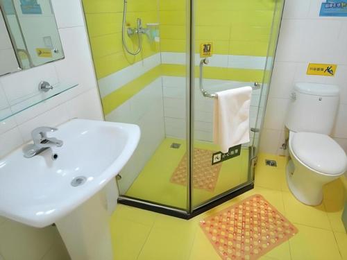 a bathroom with a shower and a sink and a toilet at 7 Days Inn Guangrao Bus Station in Dongying