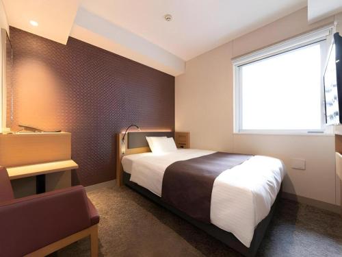 a hotel room with a bed and a window at KEIKYU EX INN Tokyo Nihombashi in Tokyo