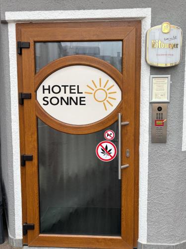 a hotel entrance door with a sign on it at Hotel Sonne in Sinsheim