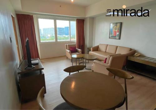 a living room with a couch and a table at La Mirada Hotel in Mactan