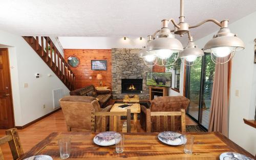 a living room with a table and a fireplace at Bonnie and Clyde in Gatlinburg