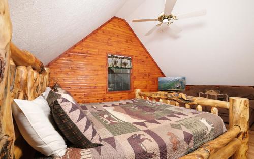 a bedroom with a bed in a log cabin at Bonnie and Clyde in Gatlinburg