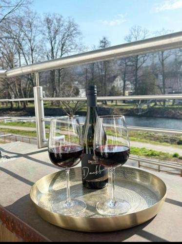 two glasses of red wine sitting on a tray at Exklusive Wohnung Mit Ahrblick 2 in Bad Neuenahr-Ahrweiler