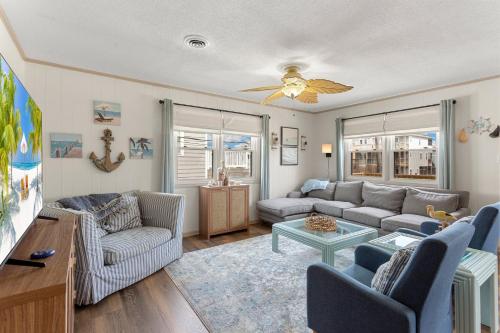 a living room with a couch and a table at 5206 - Hogg Heaven in Croatan Shores