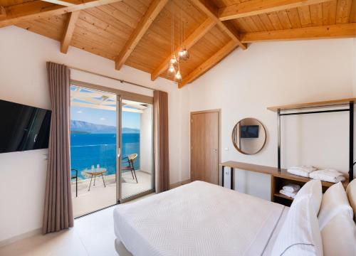 a bedroom with a bed and a view of the ocean at Diamanti Villas in Nikiana