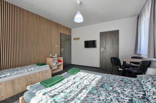 a hotel room with two beds and a table at willa wena in Krynica Zdrój