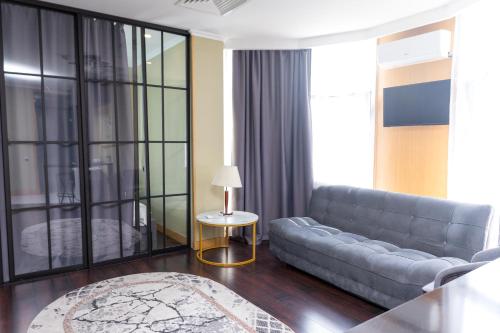 a living room with a couch and a table at Arnas hotel in Almaty
