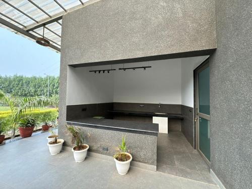 a building with a large wall with potted plants at Arzen Farms in Zirakpur