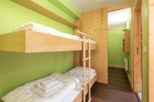Una cama o camas en una habitación de Alpe d'Huez Houses - 2 chambres à la Menandiere vue magnifique