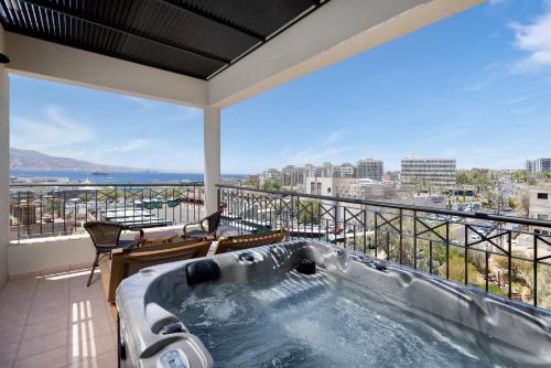 a hot tub on a balcony with a view at Comfort Hotel and Spa - Adults Only in Eilat