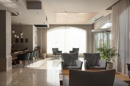 a lobby with chairs and a waiting room with a table at Comfort Hotel and Spa - Adults Only in Eilat