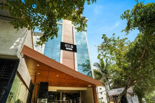 a building with a sign on the side of it at Super Hotel O Bangalore Near Reva Circle Formerly CKA Boarding in Bengaluru