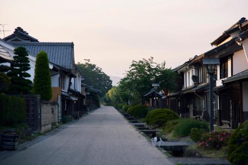 an empty street in a village with houses at Travel Stop UNNOWA in Tomi