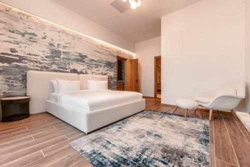 a white bedroom with a white couch and a rug at Kass Diamond Resort in Tsalka