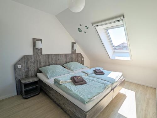 a bedroom with a bed with towels on it at Greenments, Apartments für Freizeit und Beruf in Geesthacht