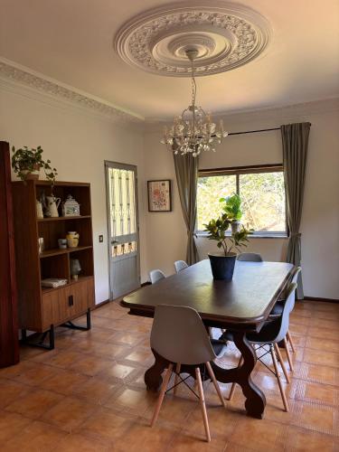 a dining room with a table and chairs and a chandelier at Vila Felicia in Cabeceiras de Basto