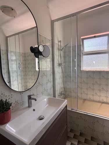a bathroom with a sink and a mirror at Vila Felicia in Cabeceiras de Basto