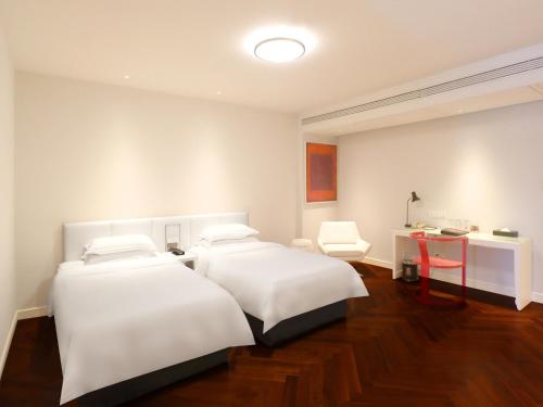 Metropolo Dahua Hotel Shanghaiにあるベッド