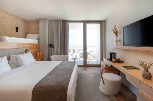 a hotel room with a bed and a television at Upon Vila - Alcochete Hotel in Alcochete