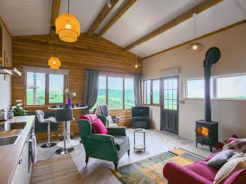 a kitchen and living room with a stove at Cowlas in Aberhosan