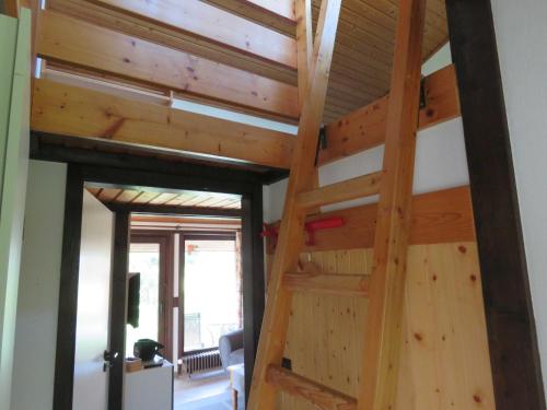 a staircase in a house with wooden ceilings at Ferienhaus Scout 42 im Feriendorf Altes Land in Hollern-Twielenfleth