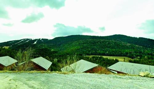 a group of buildings sitting on top of a hill at Chalet Les Balcons du Grand Puy in Seyne