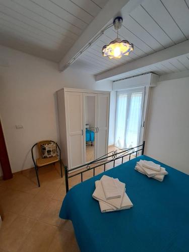 a bedroom with a blue bed with a blue blanket at Case Vacanza Torre Canne in Torre Canne