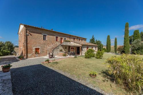 an external view of a stone house with a yard at Poggio D'Arno in Asciano