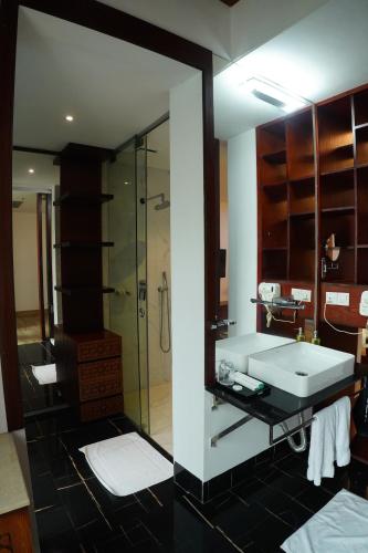 a bathroom with a sink and a shower at Empyrean Dhaka City Centre in Dhaka